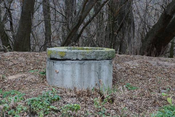 istock old gray concrete sewer stands in dry grass 1187974275