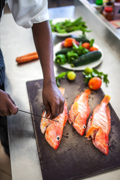 istock Chef preparing fish or seafood meal 1187975527