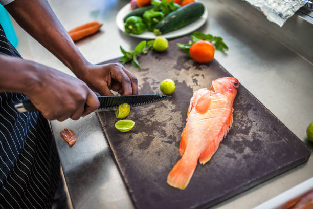 istock Chef preparing fish or seafood meal 1187975698