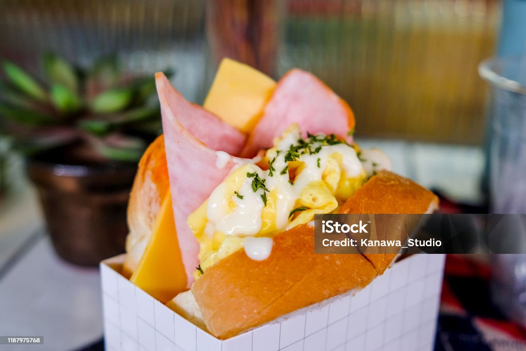 Delicious egg sandwich with ham & cheese Close up egg sandwich with ham & melted Cheese inside white paper box container Sandwich Stock Photo