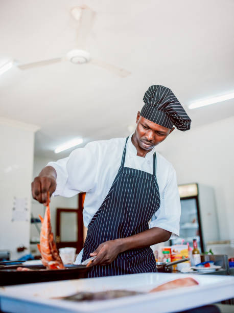 istock Chef preparing fish or seafood meal 1187976313