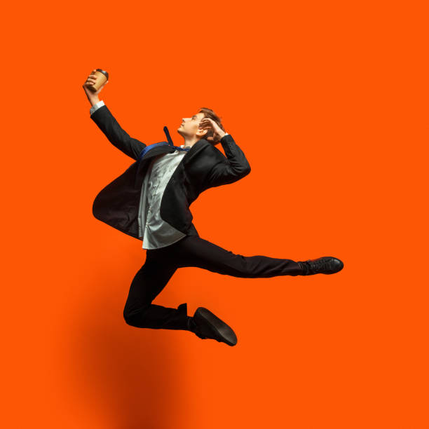 istock Man in casual office style clothes jumping isolated on studio background 1187976775