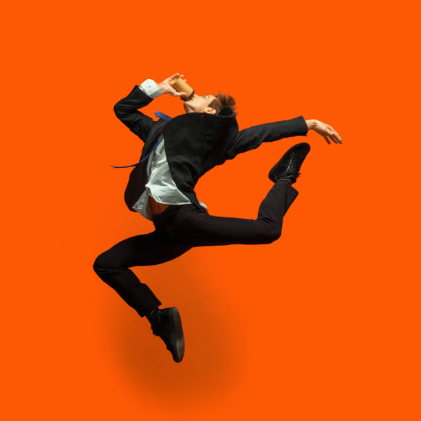 istock Man in casual office style clothes jumping isolated on studio background 1187976787