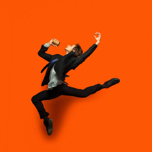 istock Man in casual office style clothes jumping isolated on studio background 1187976788