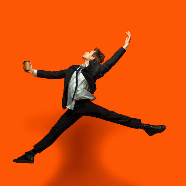 istock Man in casual office style clothes jumping isolated on studio background 1187976789