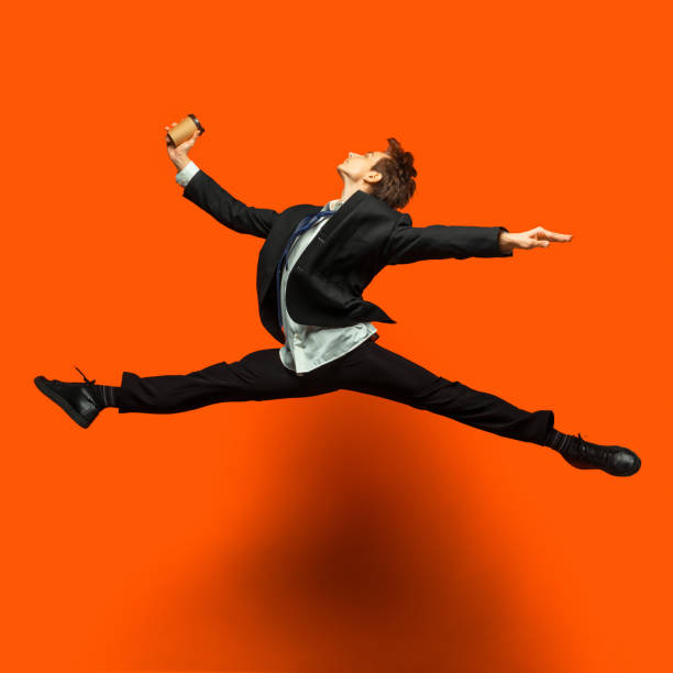 istock Man in casual office style clothes jumping isolated on studio background 1187976790