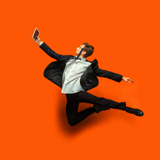 istock Man in casual office style clothes jumping isolated on studio background 1187976802