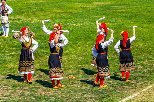 Varvara, Bulgaria- March 24, 2019: Female Bulgarian folk dancers in national costumes at the National Festival Dervishi Varvara 2019, village of Varvara, Pazardzhik Province, Rhodope Mountains