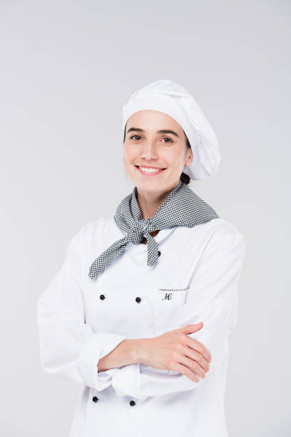 istock Pretty young chef in white uniform looking at you while crossing arms by chest 1187980355
