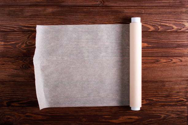 istock Baking paper roll over wooden background 1187980908