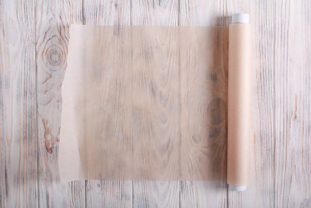 istock Baking paper roll over wooden background 1187980991
