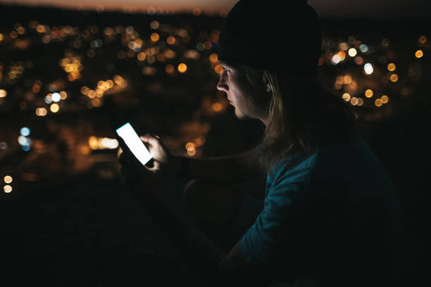 istock Man using mobile phone sitting at viewpoint in the evening in Goreme Cappadocia 1187981003