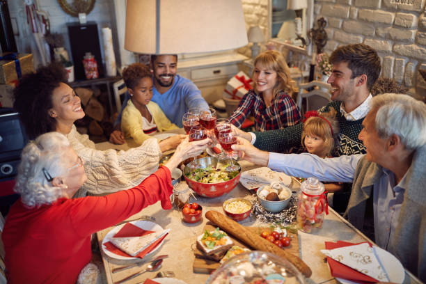 large family clinking glasses on Christmas dinner