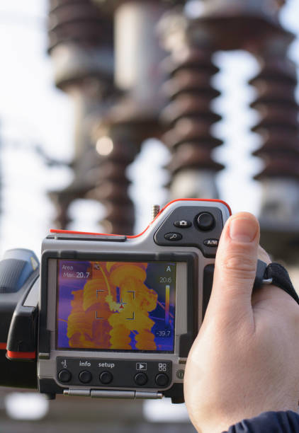 istock Engineer works with thermal infrared camera in electricity substation 1187982200