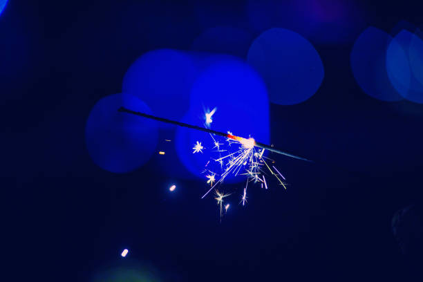 istock christmas sparkler glowing in the dark 1187982352