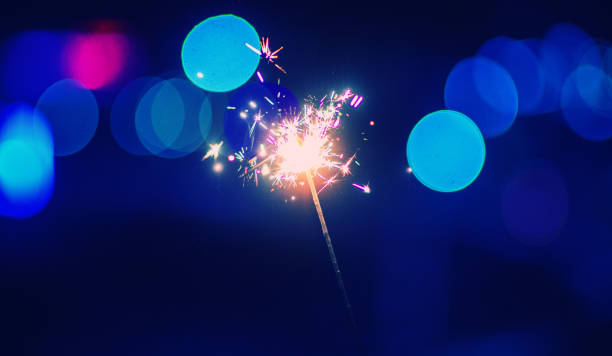 istock christmas sparkler glowing in the dark 1187982360