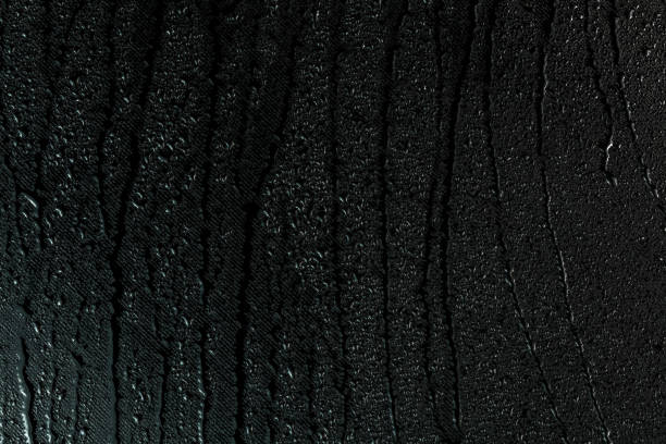 istock water drops on flat black rubber surface macro background with smudges 1187990867