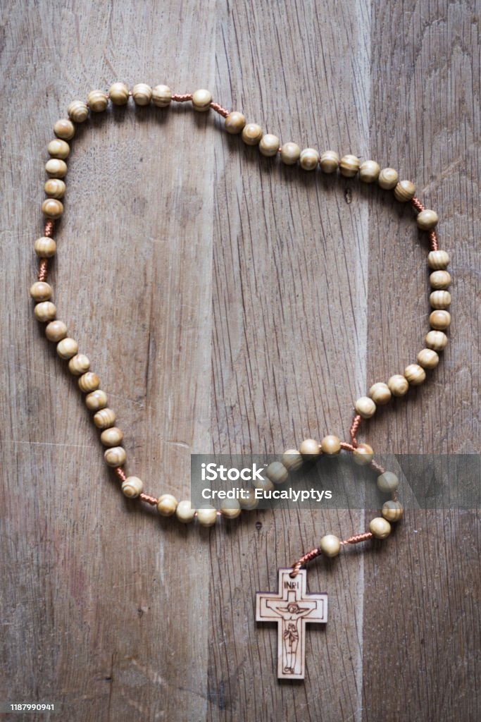 Rosary Rosary on woodden floor. No people. Close shot. Rosary Beads Stock Photo