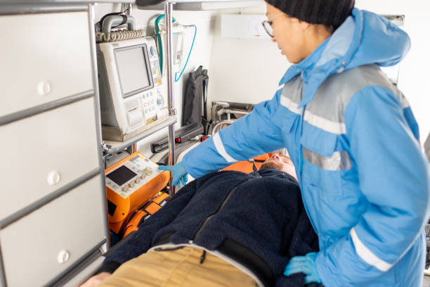 istock Young paramedic in uniform pressing button on medical first aid equipment 1187991247