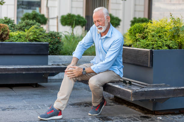 istock Senior Businessman with Knee Problems in the City Streets 1187991983