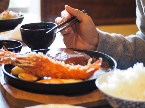 A man eating Japanese set menu lunch with chopsticks