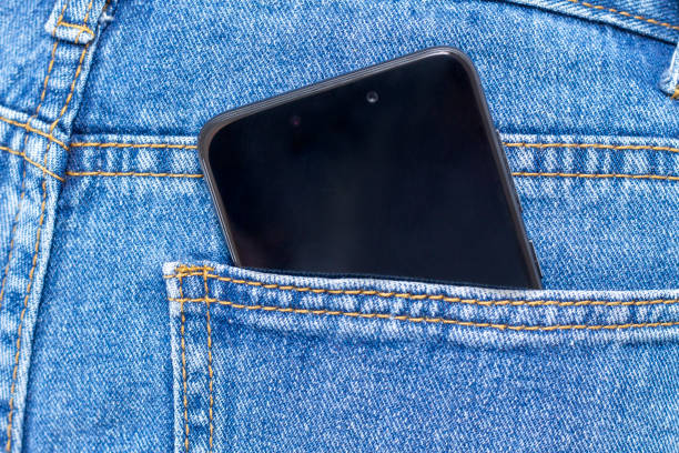 istock mobile phone in jeans pocket with black screen. focus on screen 1187993488