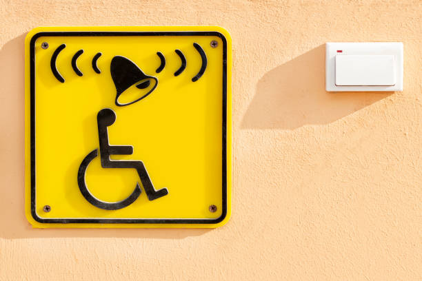 Disabled help call button. yellow plate with the image of a disabled person and a call button. the complexity of restricting human movement.