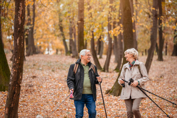 istock Senior Couple Hiking With Their Dog 1187993557