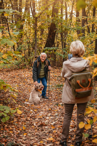 istock Senior Couple Hiking With Their Dog 1187993564