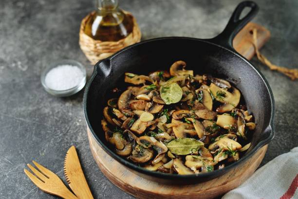 istock Fried mushrooms with onions, garlic, bay leaf and dill. 1187993569