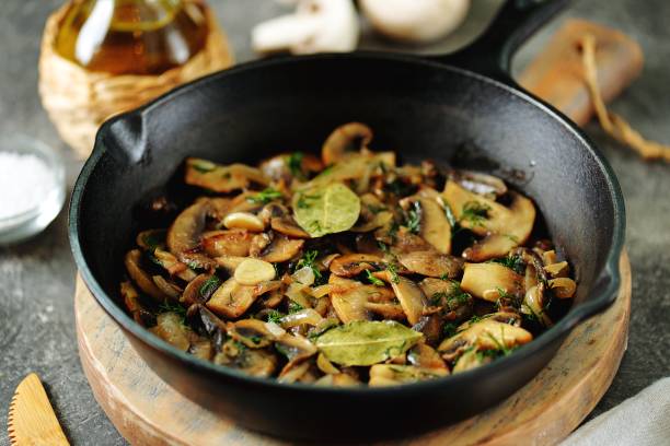 istock Fried mushrooms with onions, garlic, bay leaf and dill. 1187993575