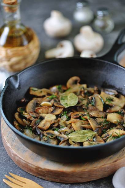 istock Fried mushrooms with onions, garlic, bay leaf and dill. 1187993595