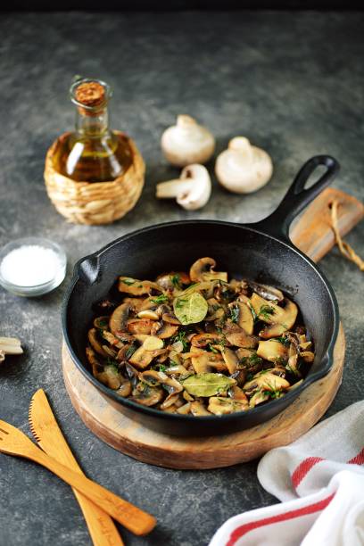 istock Fried mushrooms with onions, garlic, bay leaf and dill. 1187993609