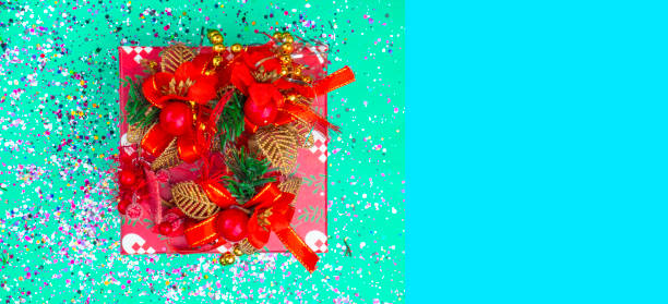 istock Red gift box in trendy mint green colors tones. Flat lay background. Festive concept. Selective focus 1187993754