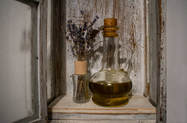 istock Lavender flowers. Oil in a glass bottle. Rustic background 1187994038