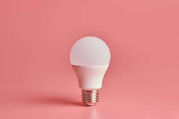 istock Energy saving light bulb, copy space, pink background. Minimal idea concept. 1187996172