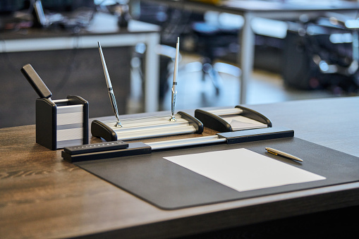 Set of objects for drawing on a wooden table. Paper, ruler, triangle, eraser, pencils, compass. Blank template for new project. 3D illustration.