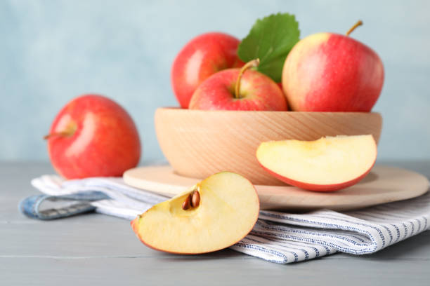 istock Bowl with apples on wooden background, close and space for text 1187999511