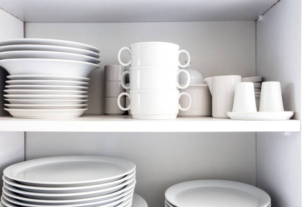istock White Cupboard with white crockery in the kitchen, various clean dishes 1187999769