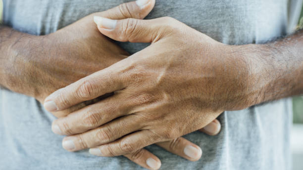 istock Young man holding his stomach in pain 1188002100