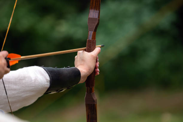 istock Archer holds his bow aiming at the target. Archery competition, outdoor activity 1188004031