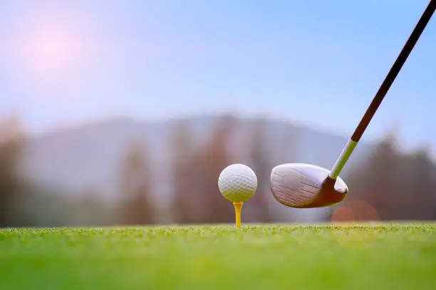 golf ball laying on wooden tee, prepare and ready to hit the ball to the destination target