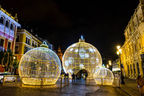 Seville, Spain - December 14, 2017: People walks near the illuminated Christmas decorations on San Francisco square in center of Seville city, Spain