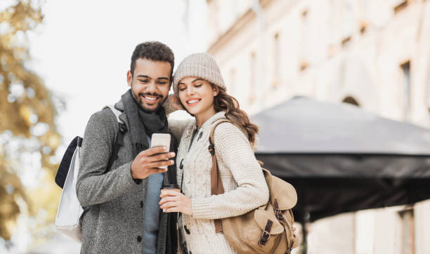 istock Beautiful happy couple using smartphone in winter 1188005043