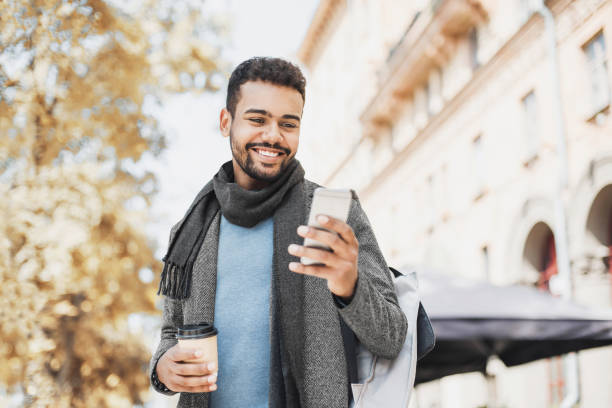 istock Handsome young man using smart phone in a city 1188005889