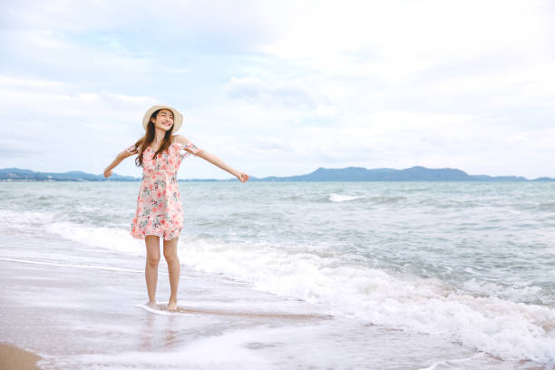 istock Travel woman walking on beach 1188006212