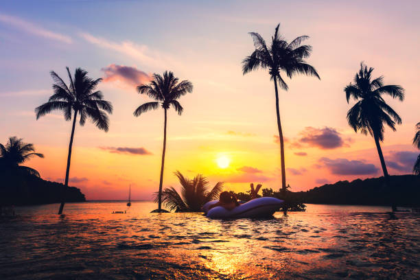istock Asian woman relax in pool on beach 1188006226