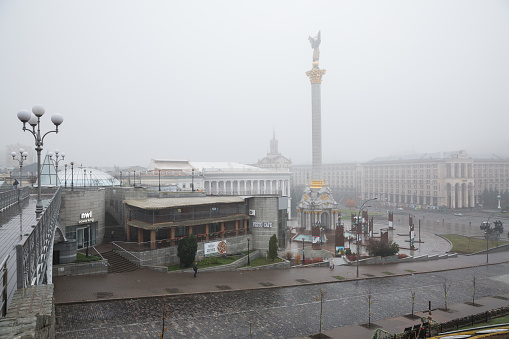 City, Kiev, Ukraine. City square in the morning mist with monument and tourists. 10.11.2019