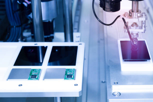 istock automatic robot arm with vacuum sucker working in the production line and assembling smartphone screens in the new innovative and high technology smartphone factory. 