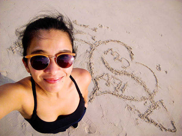 New year 2025 written on sandy beach with waves